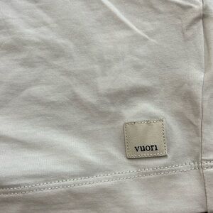 White-ish gray Vuori tank top. Never worn. Size medium.
